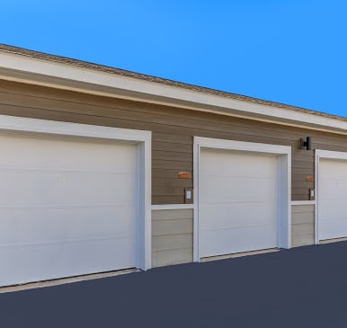 a row of three garage doors on the side of a building