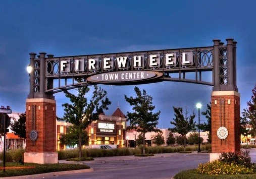 A sign that says "Firewheel" is in front of a building.