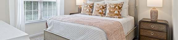a bedroom with a bed and a ceiling fan at The Met Apartment Homes, Hattiesburg, 39402
