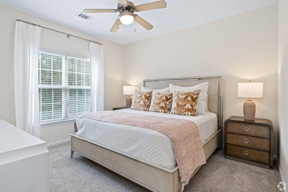 a living room with a kitchen in the background at The Met Apartment Homes, Hattiesburg, MS, 39402