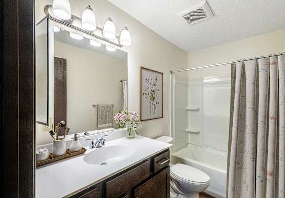 the preserve at ballantyne commons apartment bathroom with sink toilet and shower
