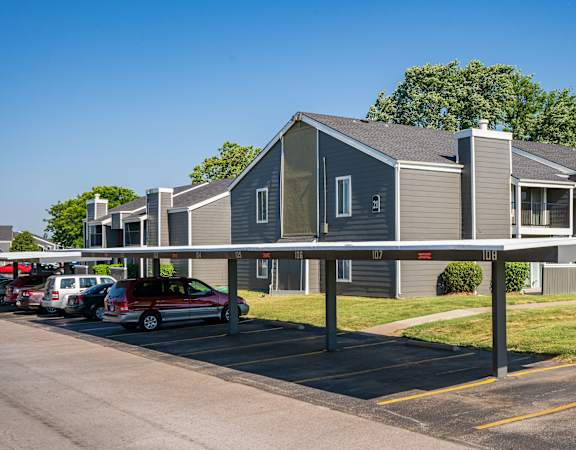 a carport in front of a row of apartment buildings