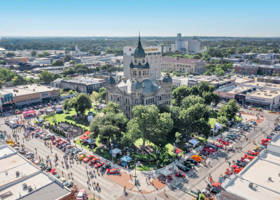 an aerial view of the city with a large building and a street