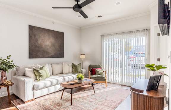 A living room with a fireplace and a painting on the wall.at 92West, West Des Moines, IA 50266