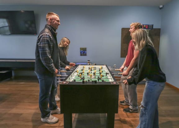 people playing a game of foosball at a table at Boulder Ridge, Minnesota, 55811