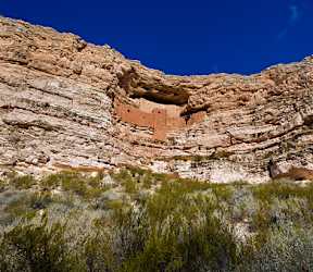 A rock formation with a small cave-like opening in the center.