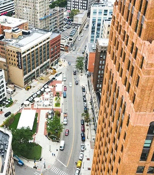 an aerial view of a city street with tall buildings