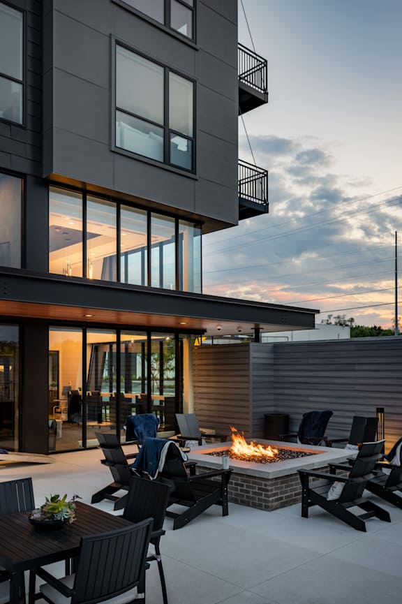 the patio has a fire pit and lounge chairs at Flats at Iron Ridge, Ferndale, 48220