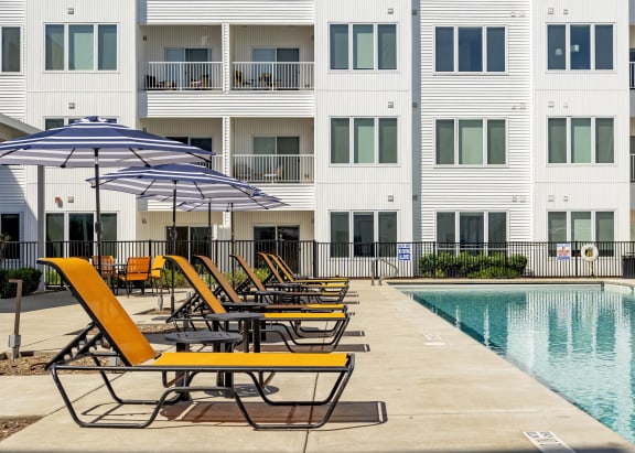 our apartments have a pool and lounge chairs and umbrellas
