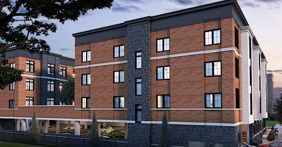 A modern building with a brick facade and a balcony with a railing.