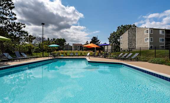 our apartments have a large pool with chairs and umbrellas