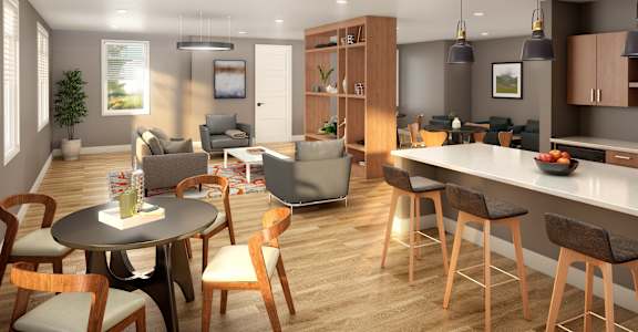 A modern kitchen and dining area with wooden floors and furniture.
