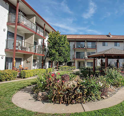a garden in front of an apartment building at Roseville Commons Senior Living, Roseville, 95678