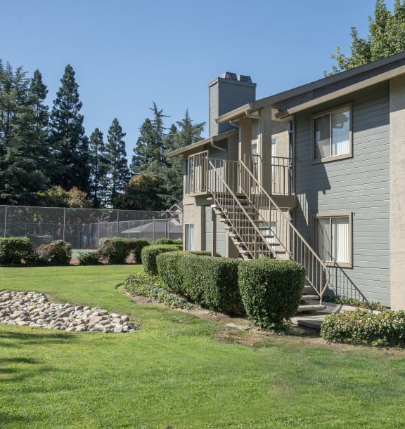 apartments exterior building balcony, enclosed patios, and large picture windows at Delta Pointe Apartments, Sacramento, CA