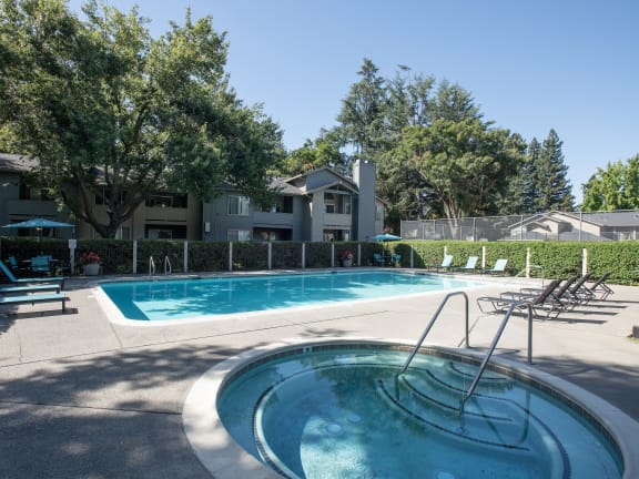 Large tree shading a building with attached garages at Delta Pointe apartments at Delta Pointe Apartments, Sacramento, 95833