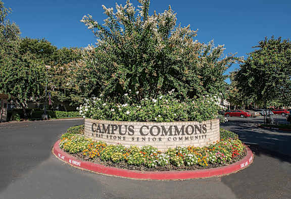 a sign for campus common at the front entrance of a parking lot at Campus Commons Senior Living, California, 95825