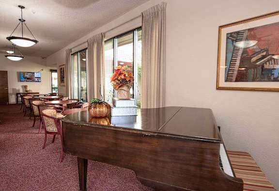 Living Area With Piano at Roseville Commons Senior Living, Roseville California