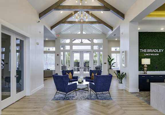 the bradley living room with blue chairs and a table