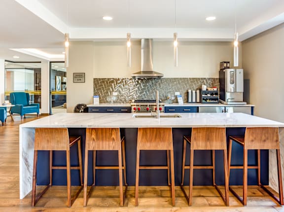 A kitchen with a bar area and a stove top oven.