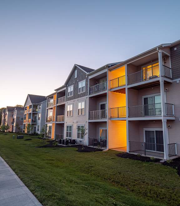 a row of town houses with a sidewalk in front of them at The Bend, Lancaster, OH