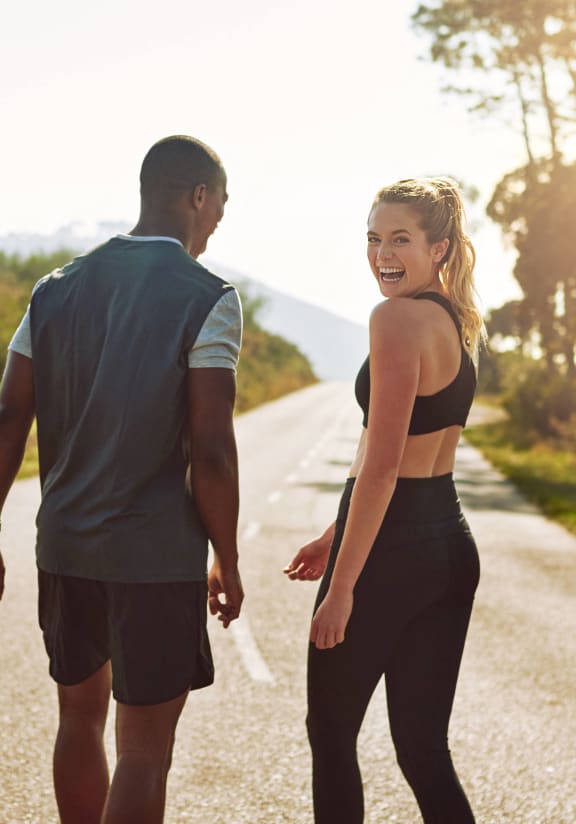 a man and a woman walking down a road