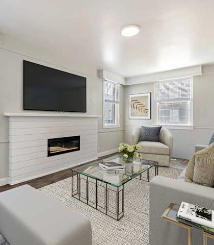 a living room with a fireplace and a television