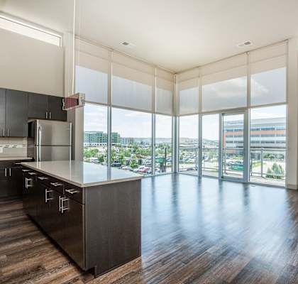 an open kitchen with a large window overlooking a city