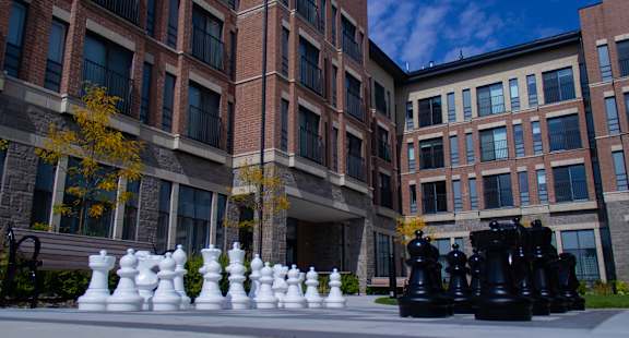 a giant chess set in front of an apartment building