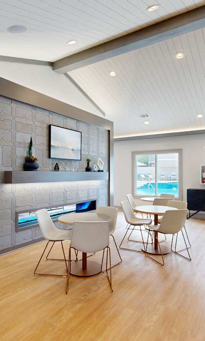 A modern kitchen with a dining table and chairs at Reserve at Park Place Apartments, Mississippi 39402