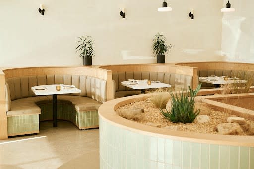 the interior of a restaurant with tables and chairs