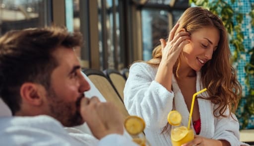 A man and a woman in bathrobes are enjoying a drink together. at 150 Marketplace, Ottawa, ON