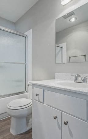 an empty kitchen with white cabinets and a sinkat The Arches Apartments, LLC, El Cajon, CA 92021