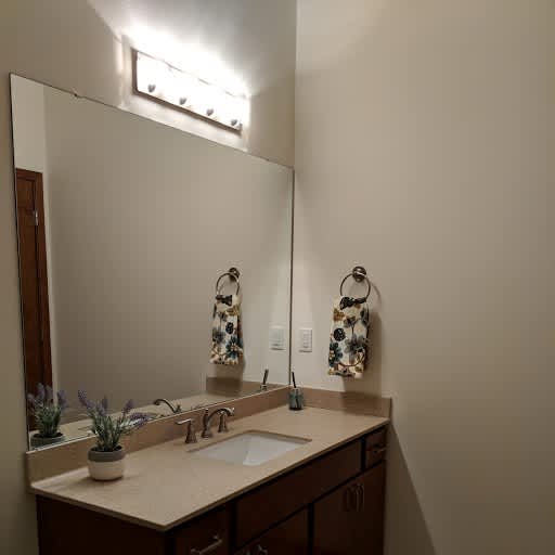 A bathroom with a sink, mirror, and towel rack. at Cornerstone & Ravenna* Apartments, Shorewood, Wisconsin