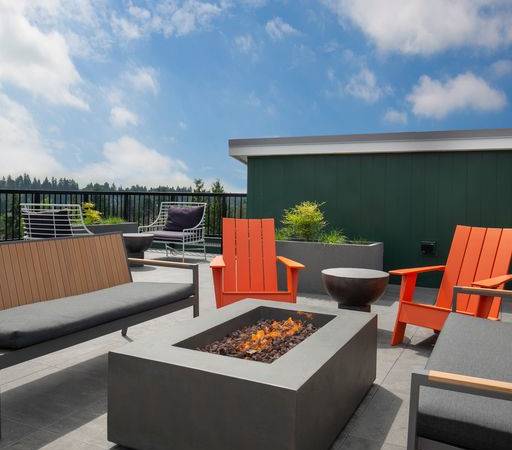 a patio with chairs and a fire pit at Sedona Apartments in Seattle, WA
