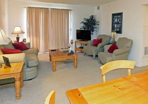 a dining room and kitchen with a table and chairs
