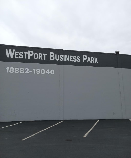 a sign for westport business park on the side of a building