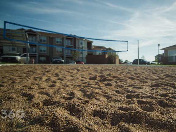 A field with apartment buildings in the background.