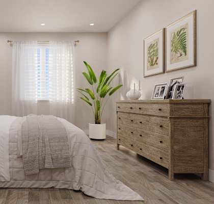 A bedroom with a large bed, a nightstand, and a dresser.