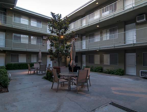 an outdoor patio area at the whispering winds apartments in pearland