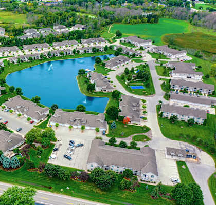 an aerial view of a neighborhood of houses around a large lake