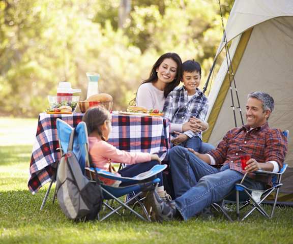 A family enjoying a picnic in a grassy field.