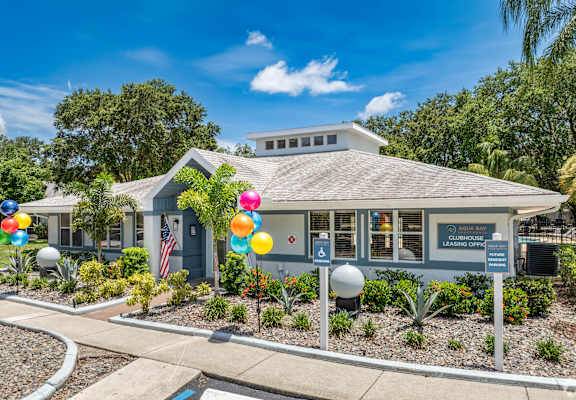 a blue building with balloons in front of it at Aqua Bay Apartments in Naples, FL 34116