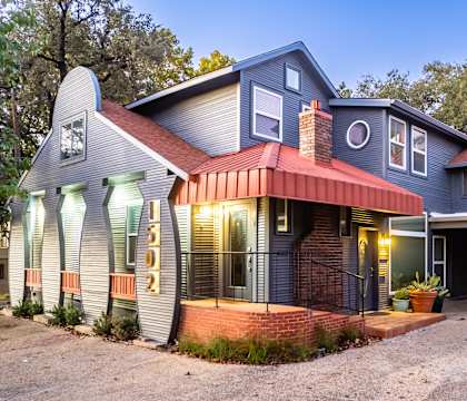A house with a red awning and a garage door.