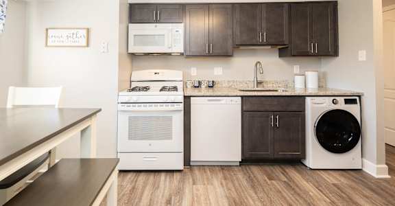 a kitchen with a washer and dryer and a counter top with a sink at Fairbrook Park, Baltimore, MD