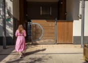 Thumbnail 2 of 4 - a woman in a pink dress is walking through a gate