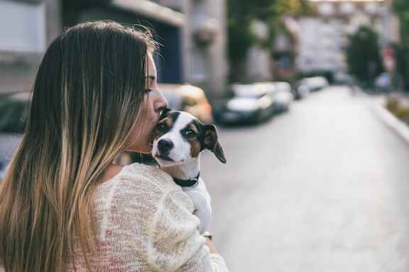 A poster promoting a pet-friendly environment with a woman and a dog.