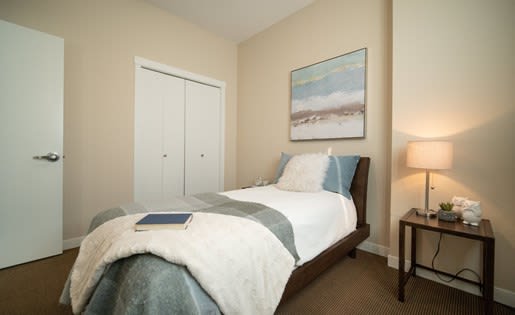 a bedroom with a bed and a nightstand