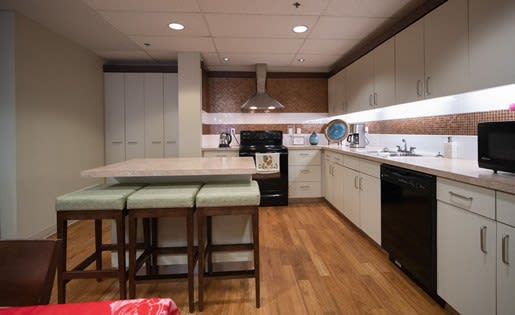 a kitchen with a center island and a stove top oven