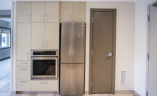 a kitchen with a refrigerator and a stove