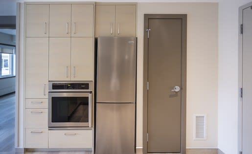 a kitchen with a refrigerator and a stove